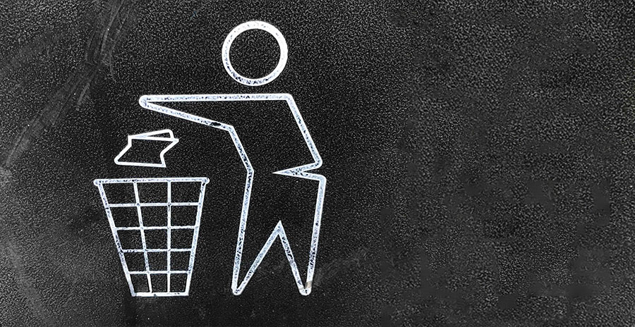 A white sketch on a black background of a person throwing a piece of trash into a waste basket
