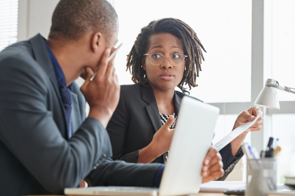 coworkers analyze data in front of a computer
