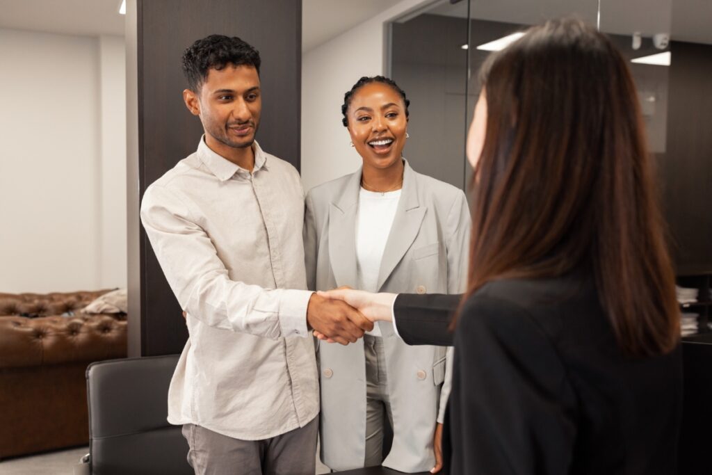 worker shakes hands with customers