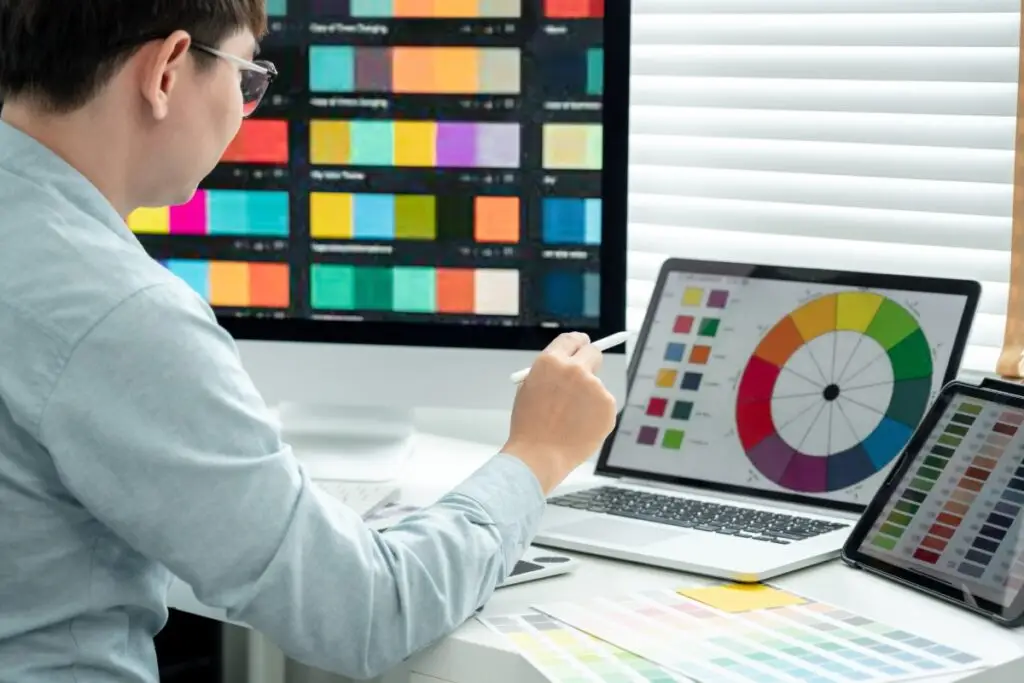 male graphic designer choosing colors for website