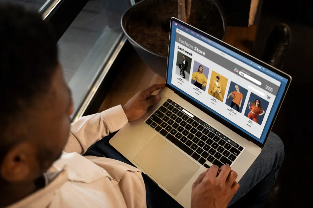 Guy with a laptop scrolling on a website