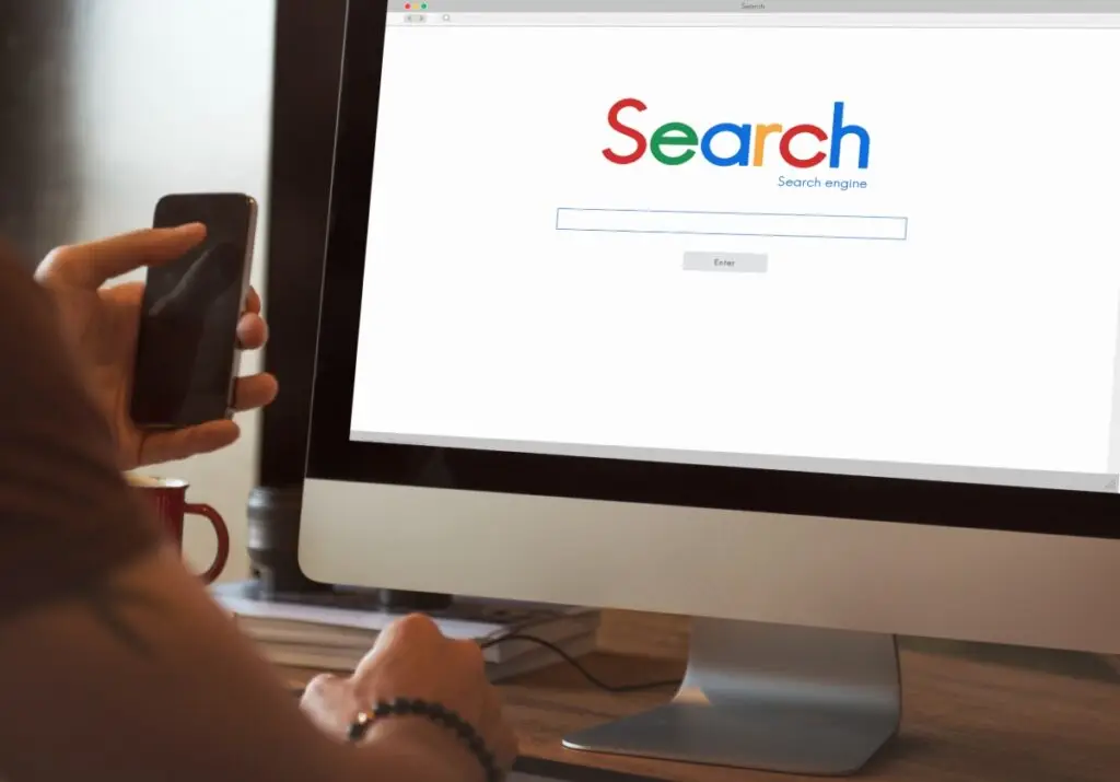 person using a computer that shows a search browser