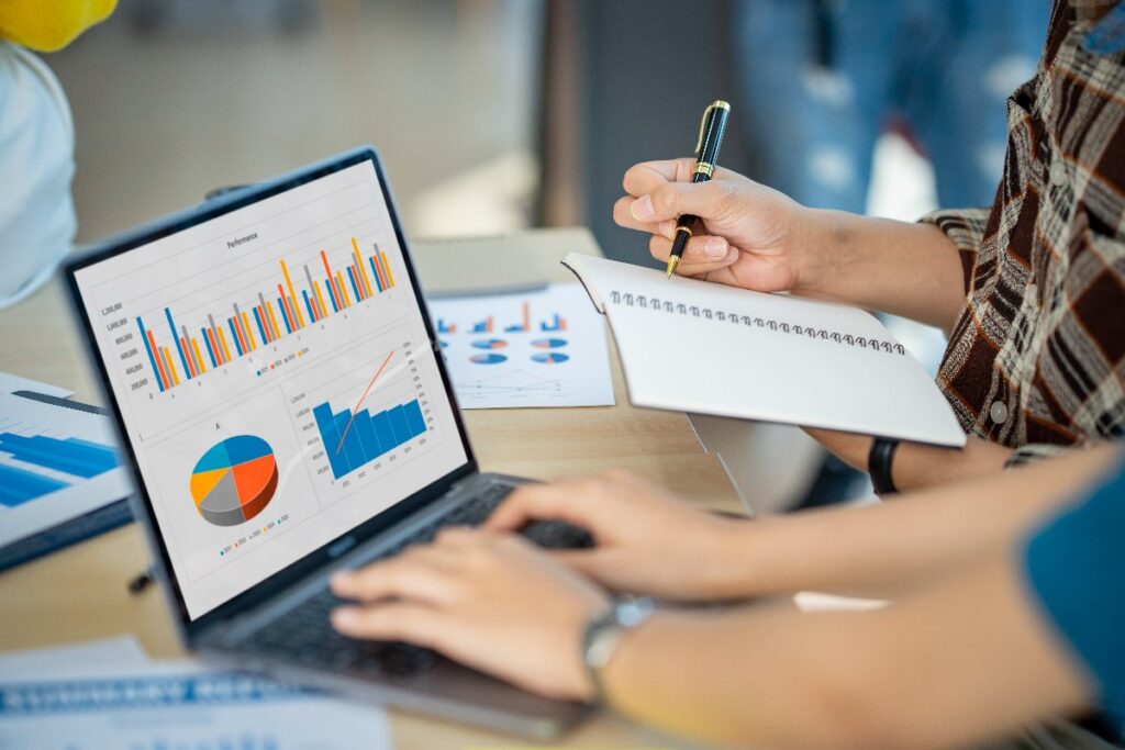 business team analyzing computer business analytics report