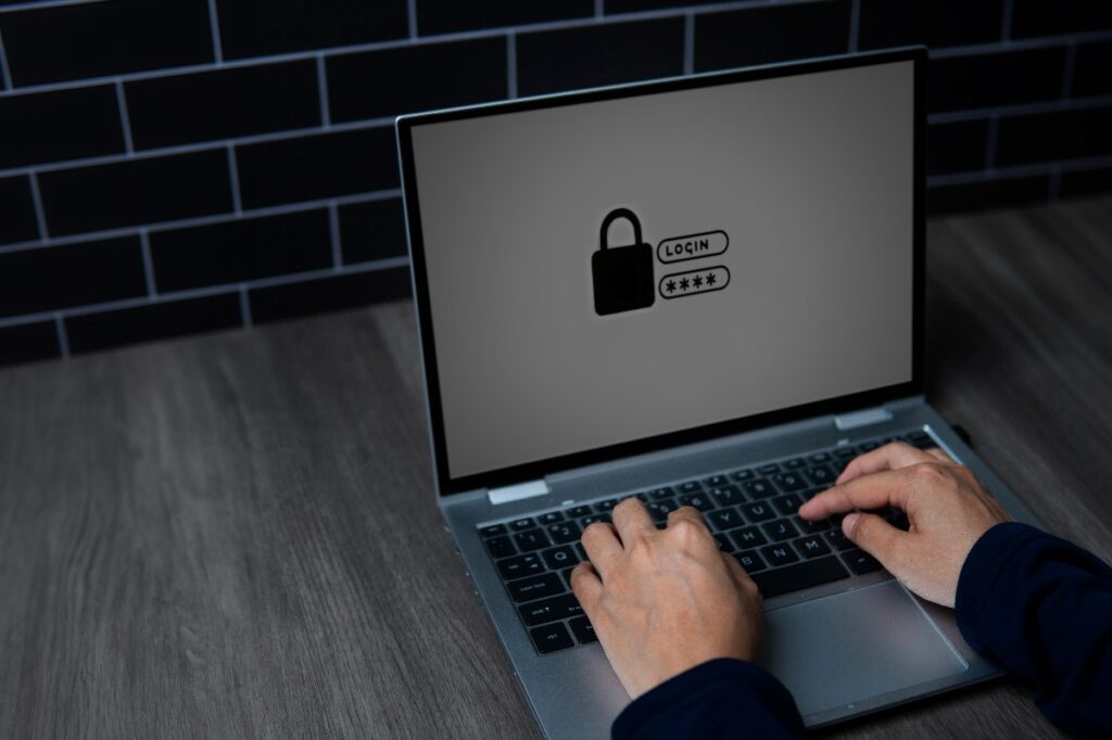 close up of hands typing on a laptop, security screen showing