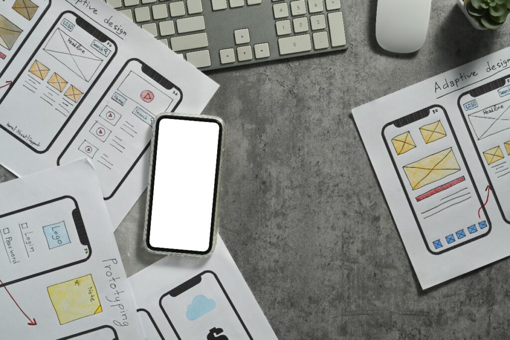 view of smart phone over pages showing mobile web designs