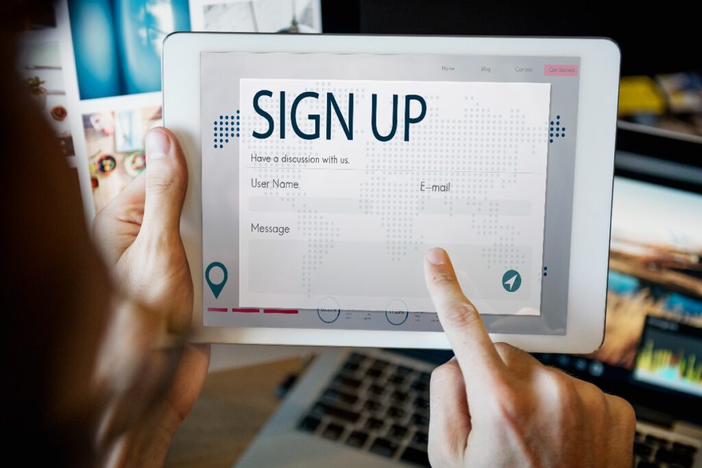 close up of person holding device showing "Sign Up" web page