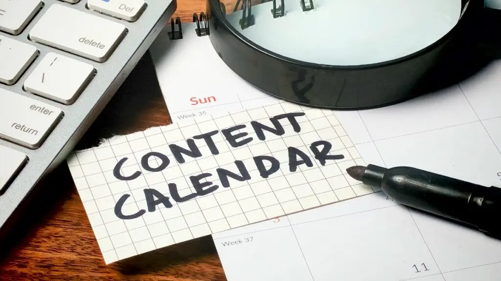 close up of desk top with paper showing "Content Calendar"