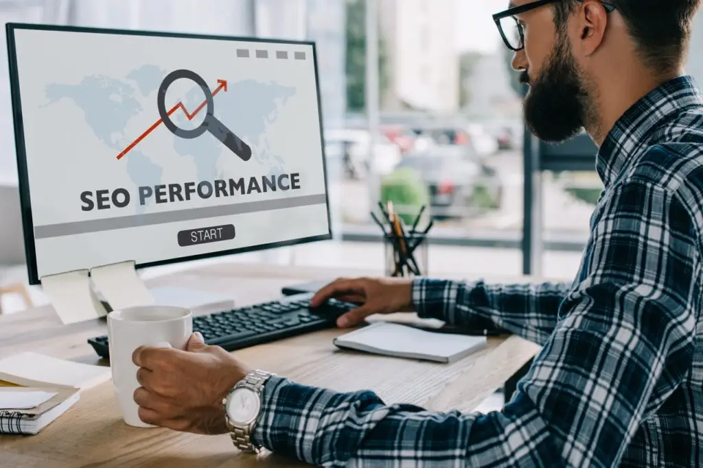man working at computer with screen showing SEO performance chart